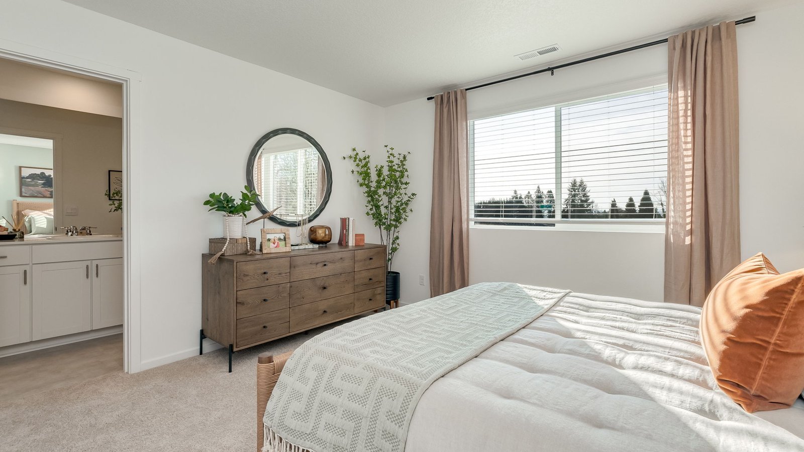 Primary bedroom with wall-to-wall carpet, a walk-in closet and an attached bathroom