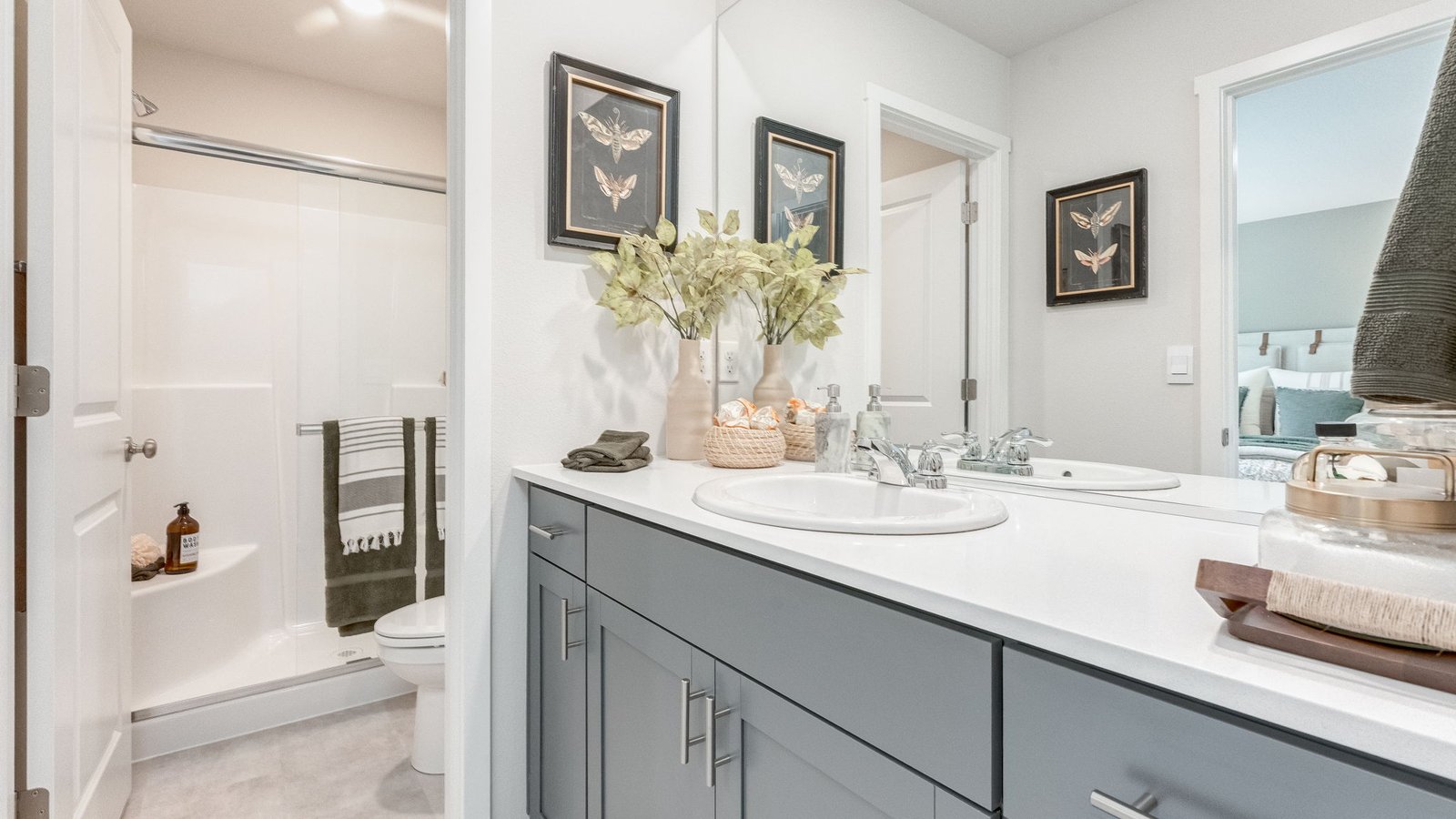 Primary bathroom with quartz counters and a walk-in shower
