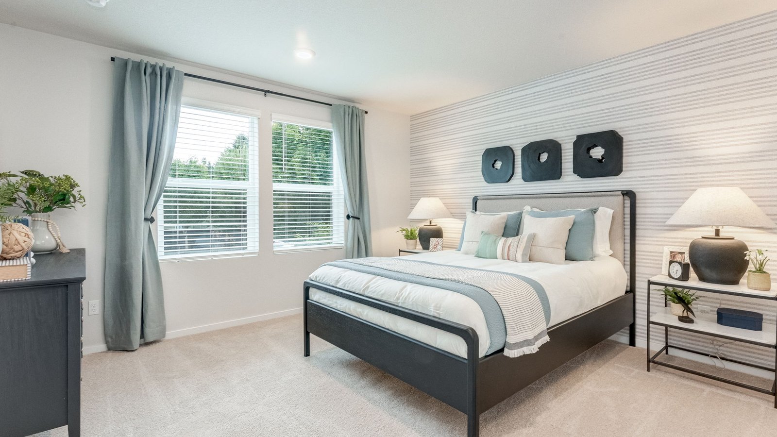 Primary bedroom with wall-to-wall carpet, a walk-in closet and an attached bathroom