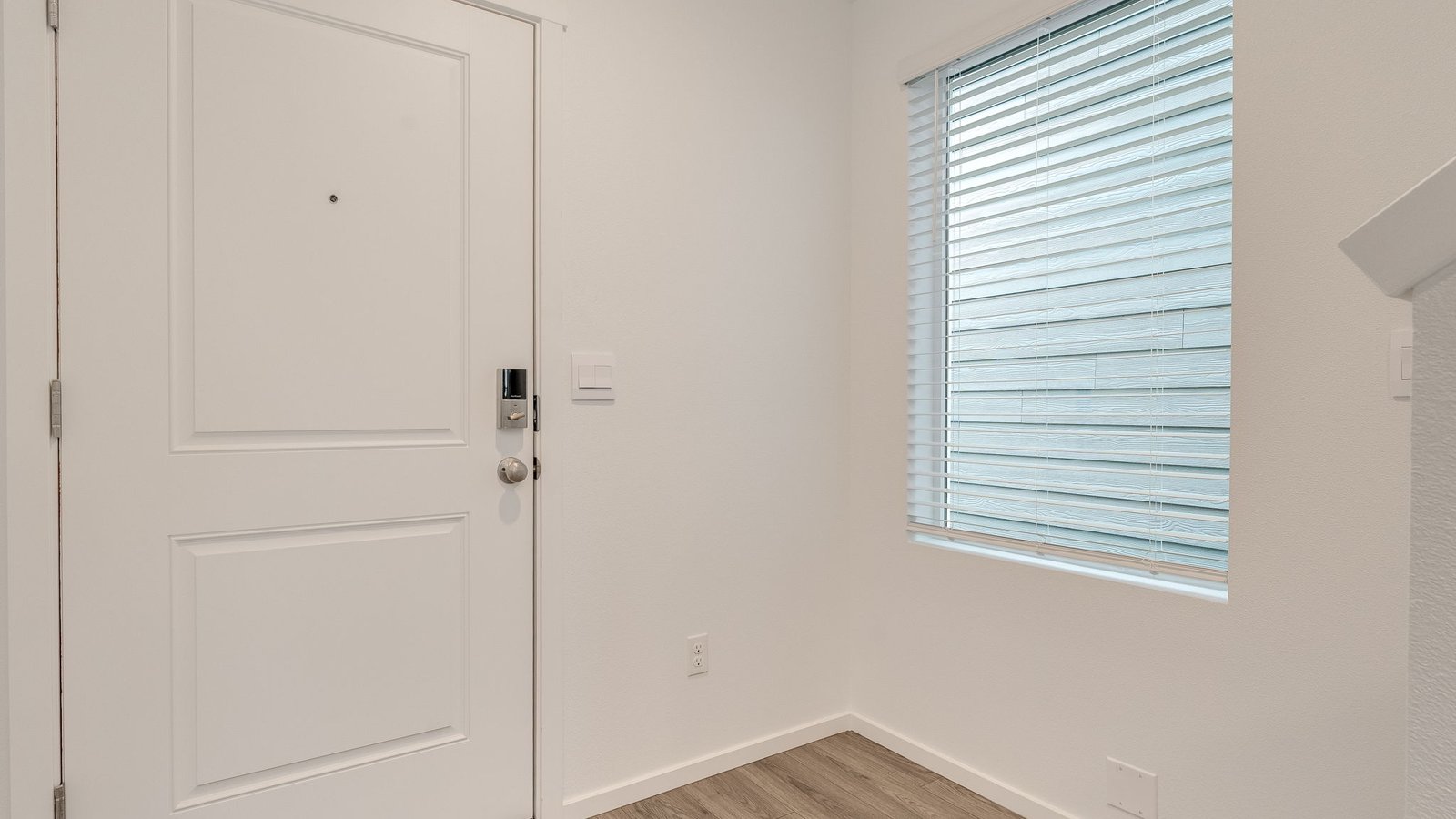 Entryway with a coat closet and laminate flooring