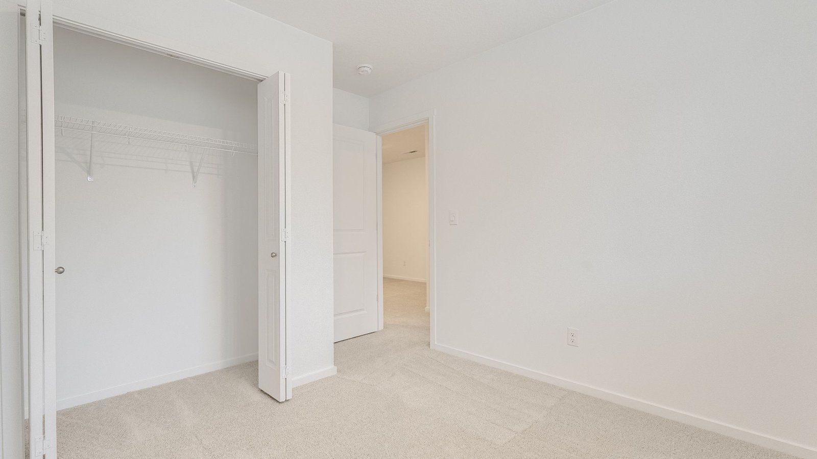 Bedroom with wall-to-wall carpet and a closet
