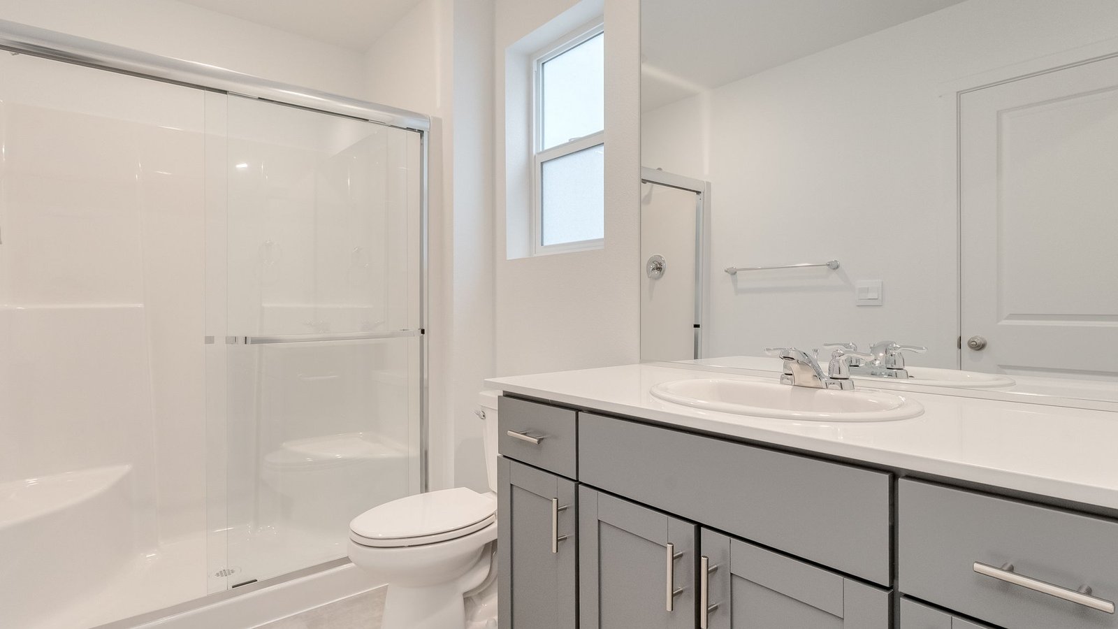 Primary bathroom with quartz counters and a walk-in shower