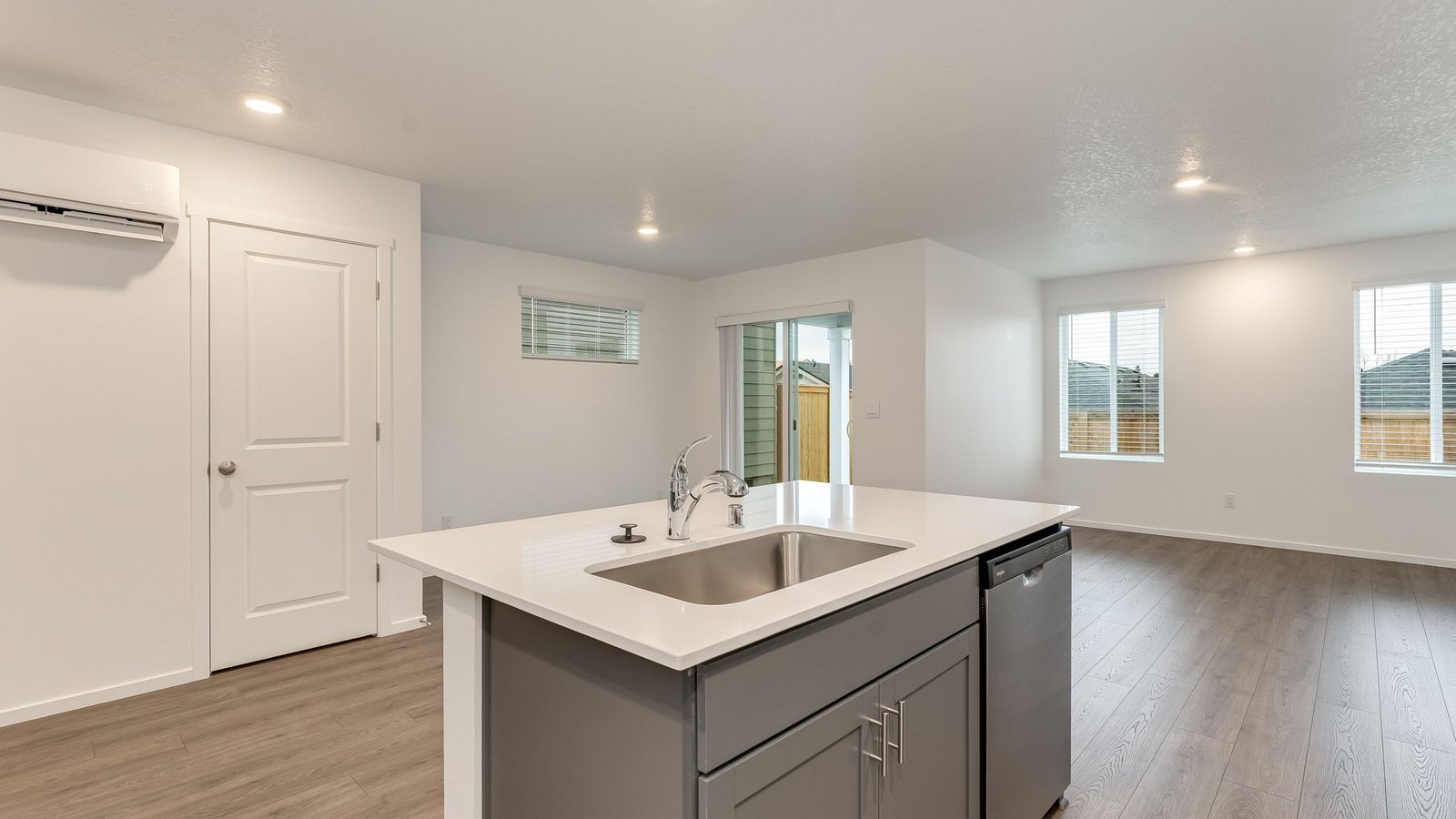 Kitchen with shaker cabinets, quartz counters, stainless steel appliances, pantry, and an island with a breakfast bar