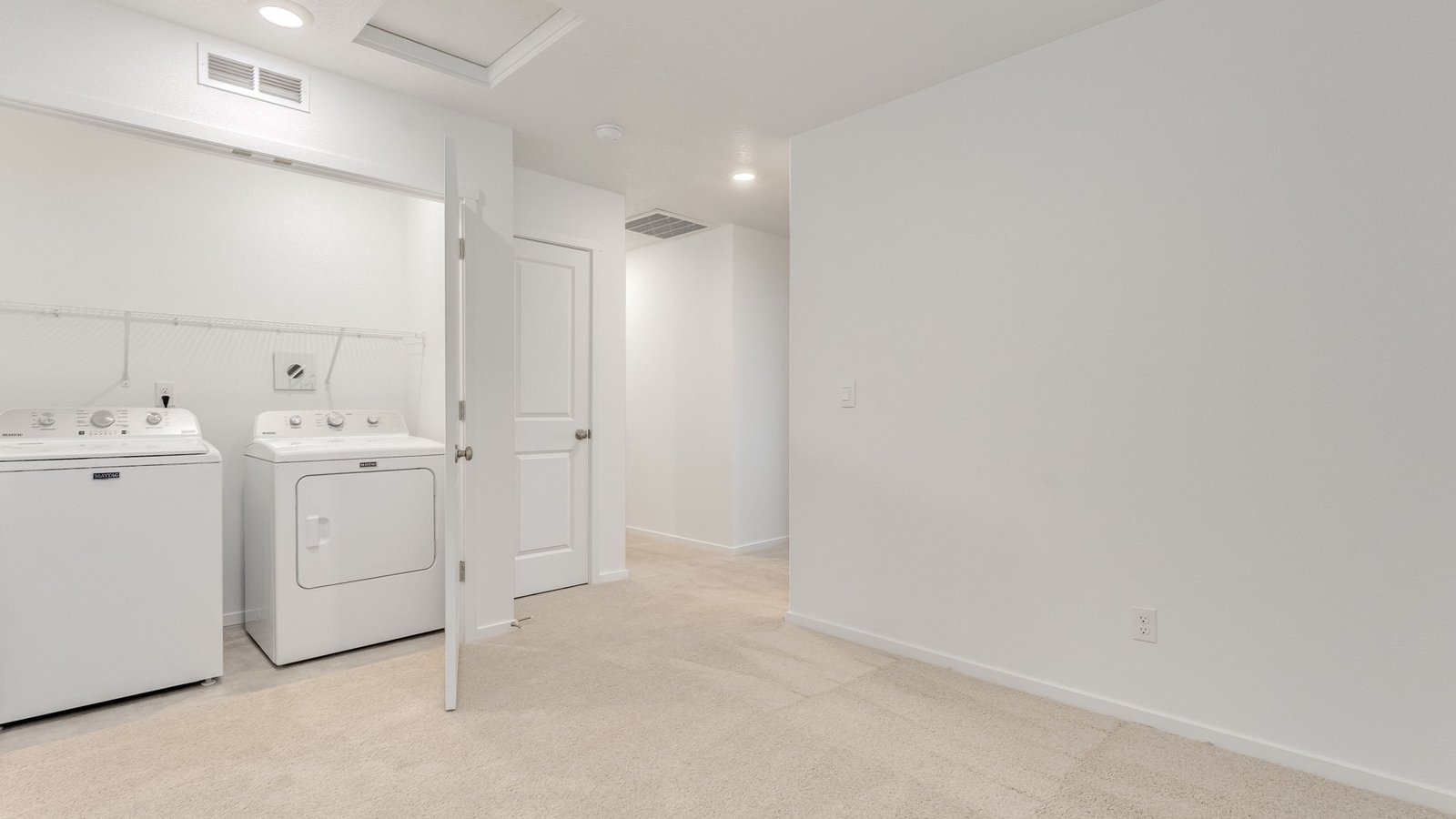 Laundry closet with wire shelves and washer and dryer hookups