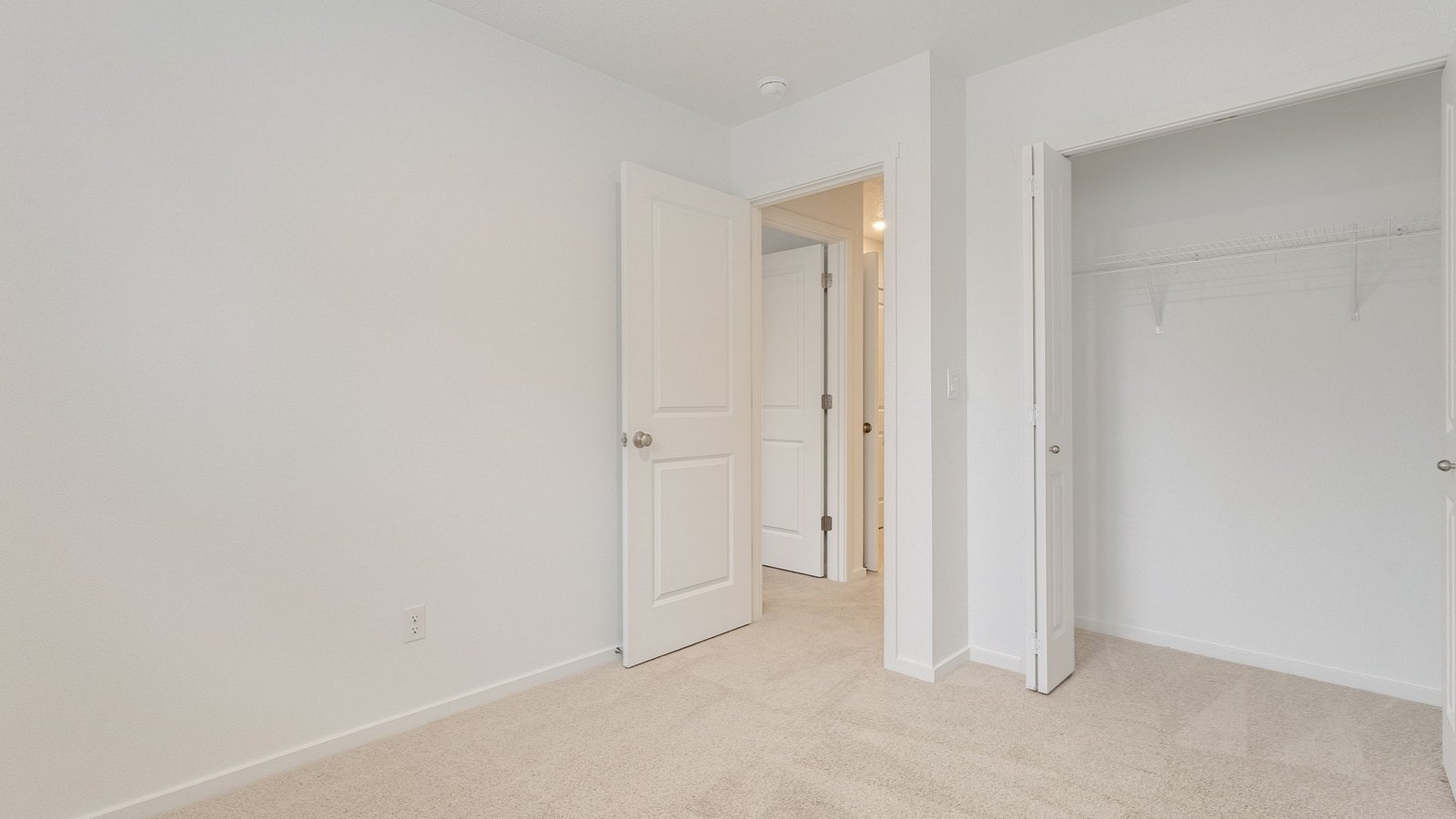 Bedroom with wall-to-wall carpet and a closet