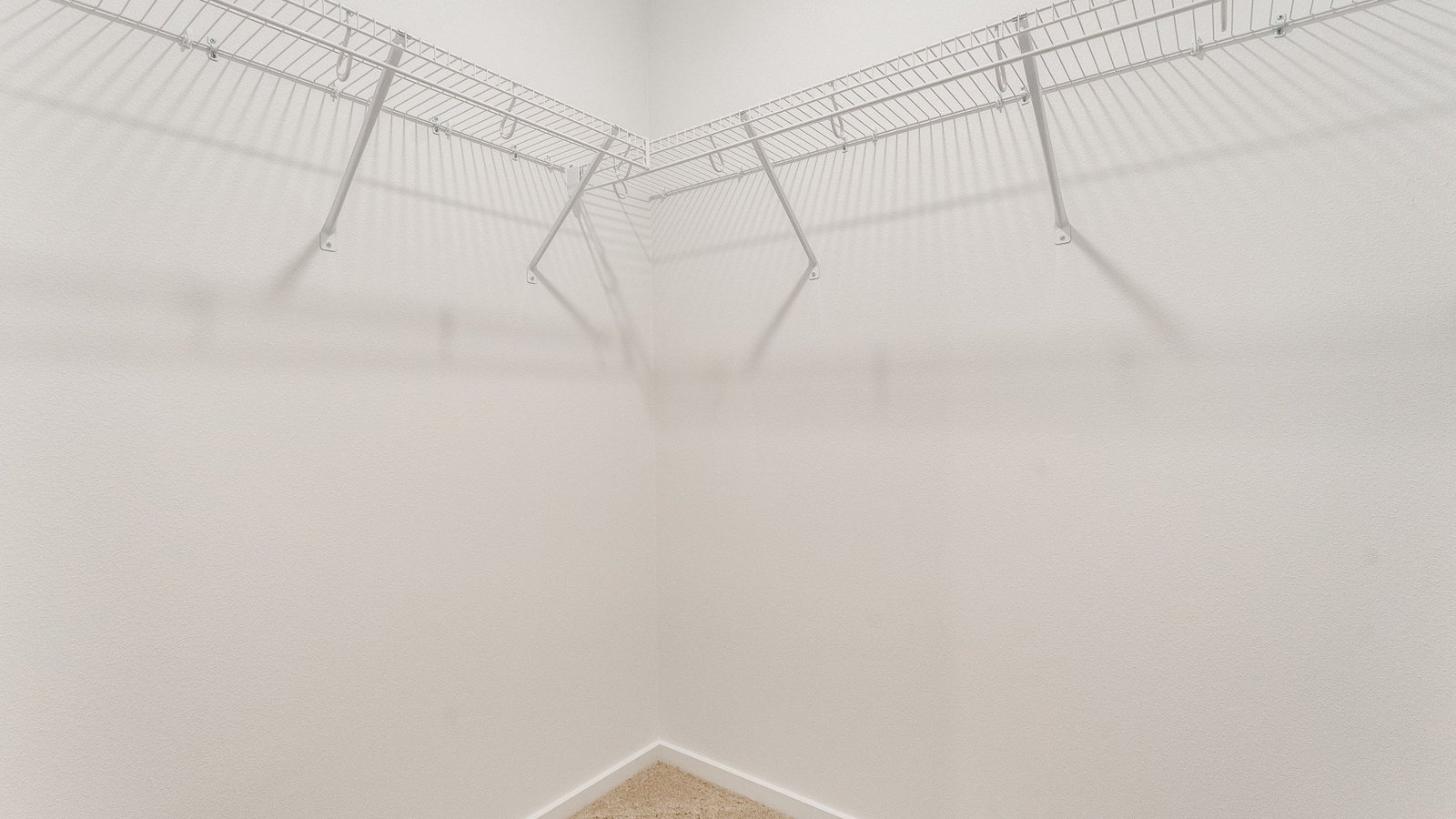 Primary bedroom walk-in closet with wire shelves