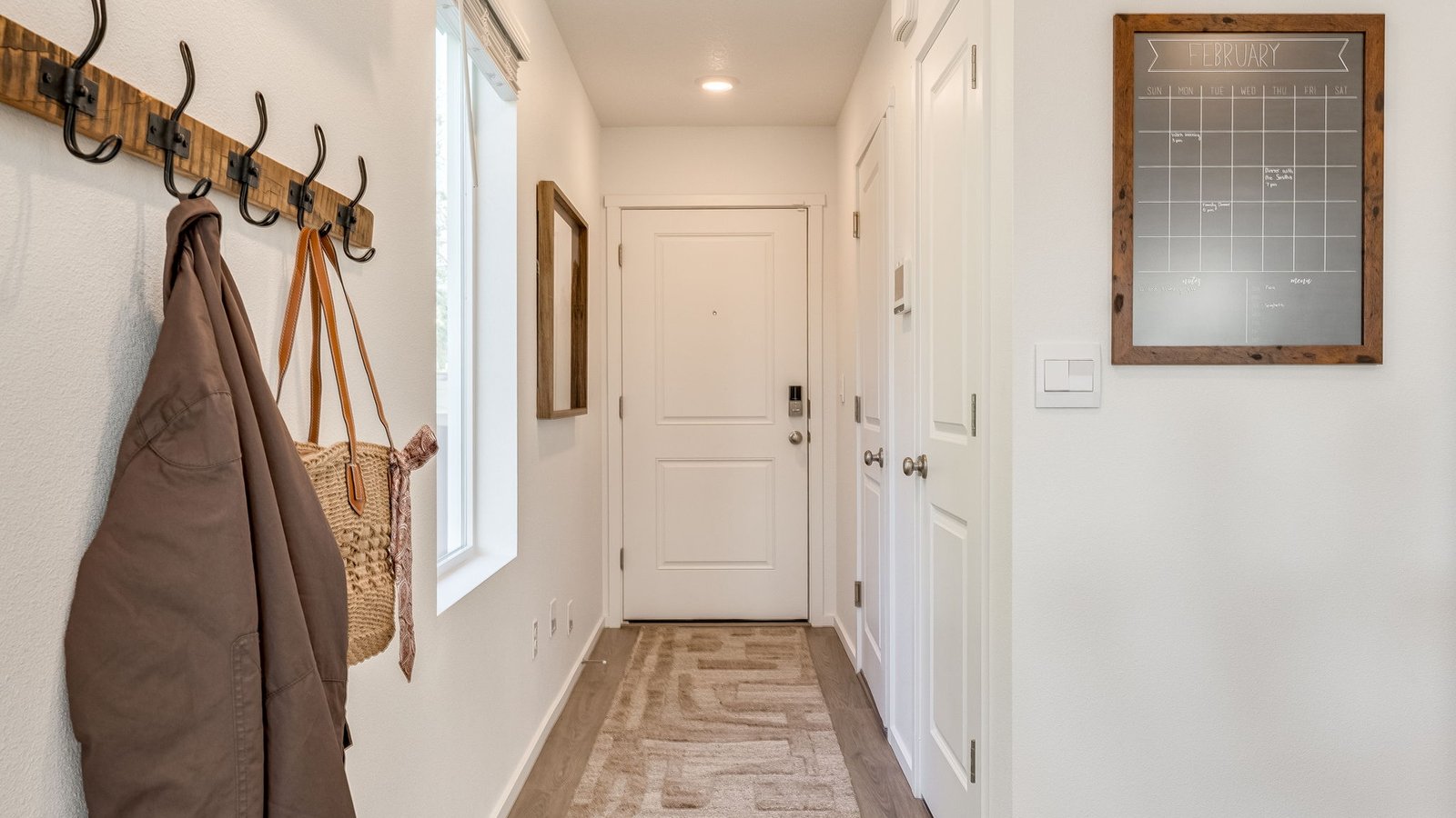 Entryway with a coat closet and laminate flooring