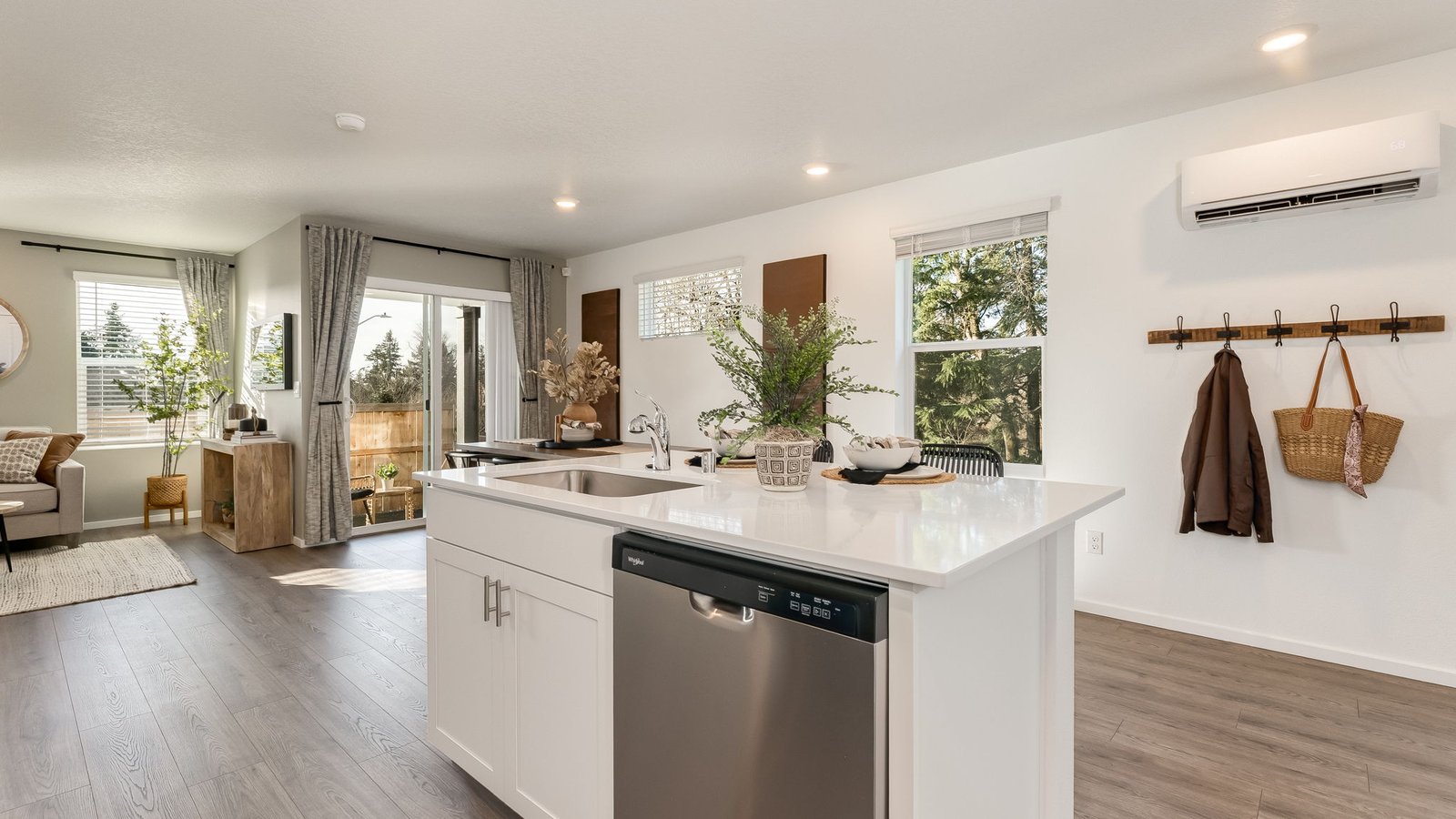 Kitchen with shaker cabinets, quartz counters, stainless steel appliances, pantry, and an island with a breakfast bar