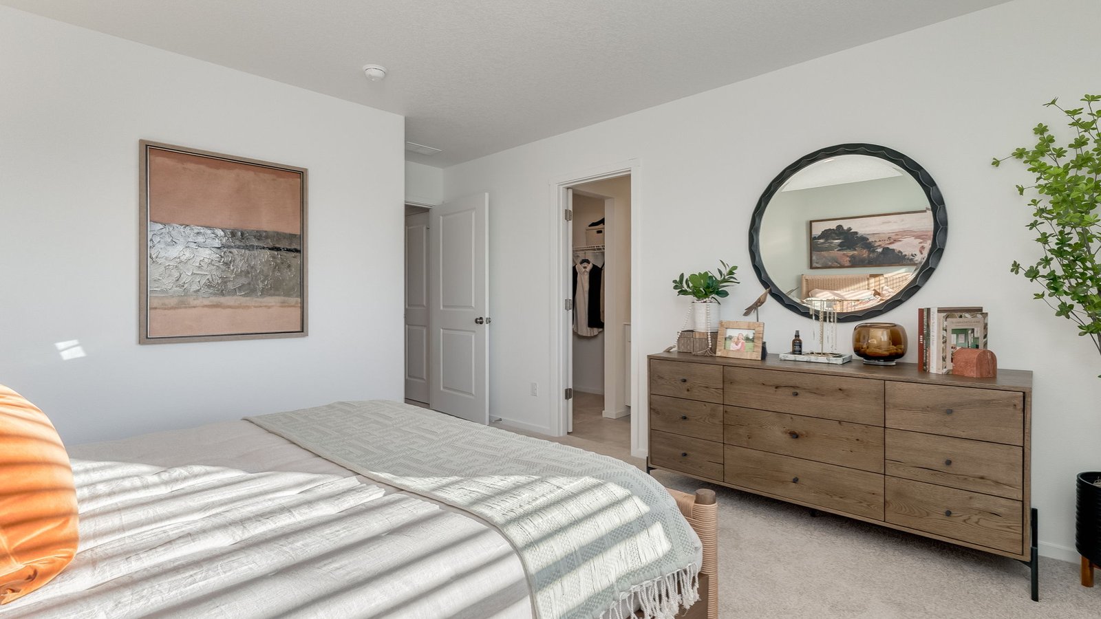 Primary bedroom with wall-to-wall carpet, a walk-in closet and an attached bathroom