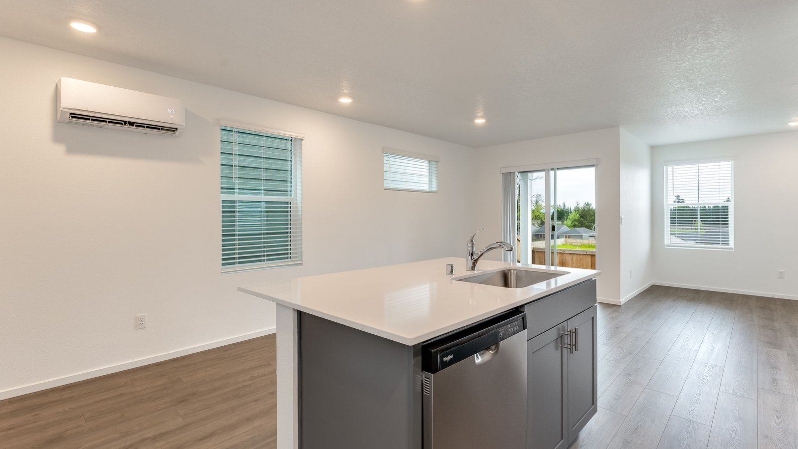 Kitchen with shaker cabinets, quartz counters, stainless steel appliances, pantry, and an island with a breakfast bar