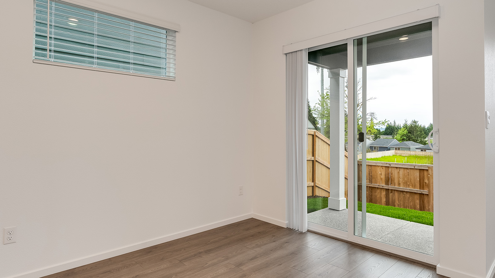 Dining area with a sliding glass door to a fenced backyard