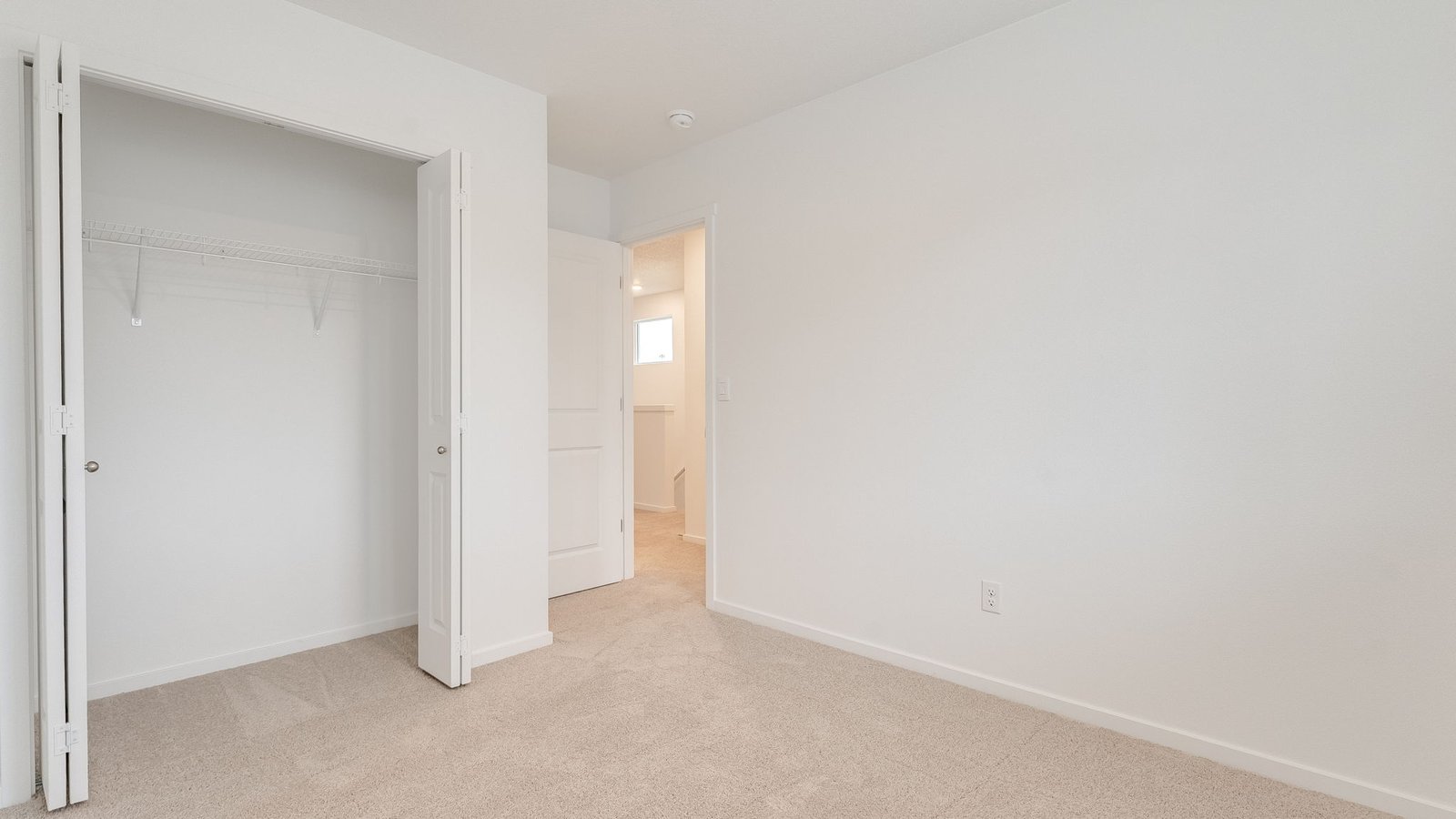 Bedroom with wall-to-wall carpet and a closet
