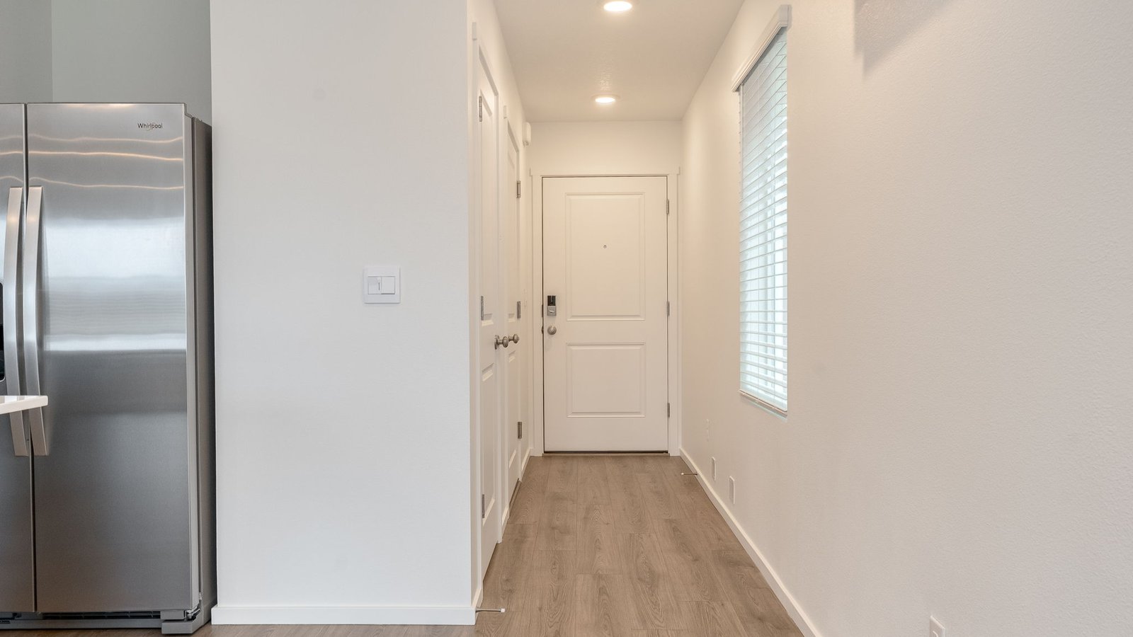 Entryway with a coat closet and laminate flooring