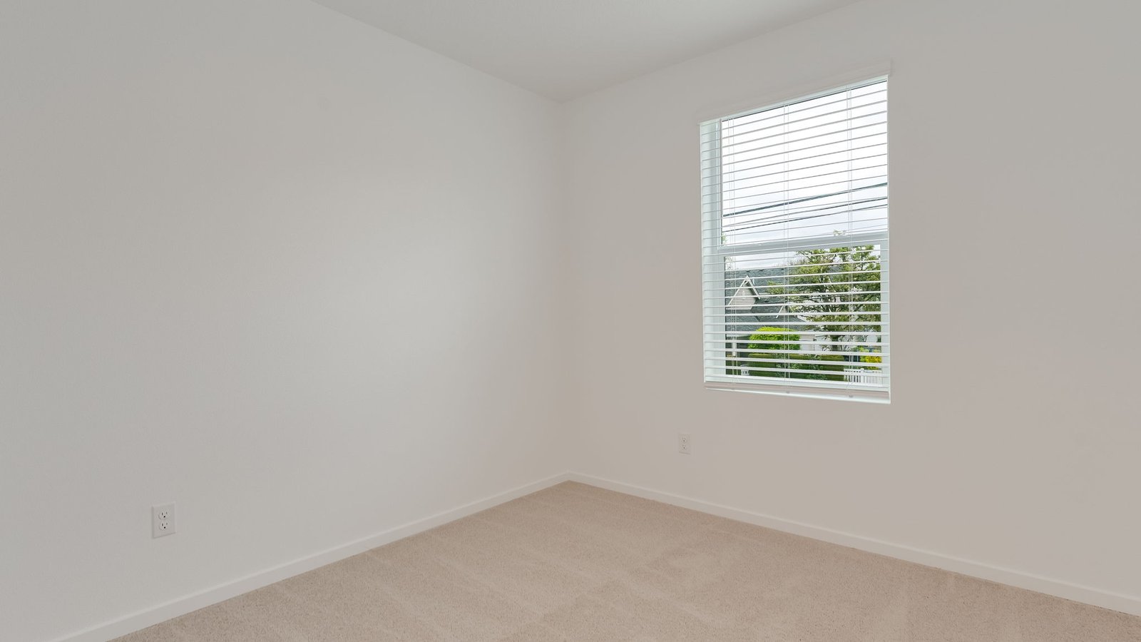 Bedroom with wall-to-wall carpet and a closet