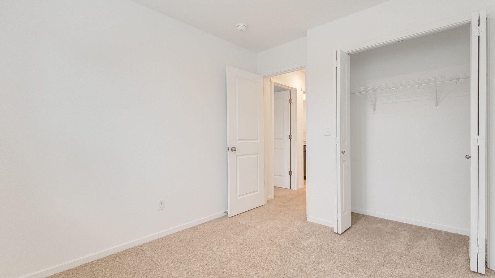 Bedroom with wall-to-wall carpet and a closet