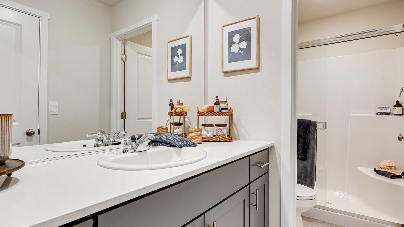 Primary bathroom with quartz counters and a walk-in shower