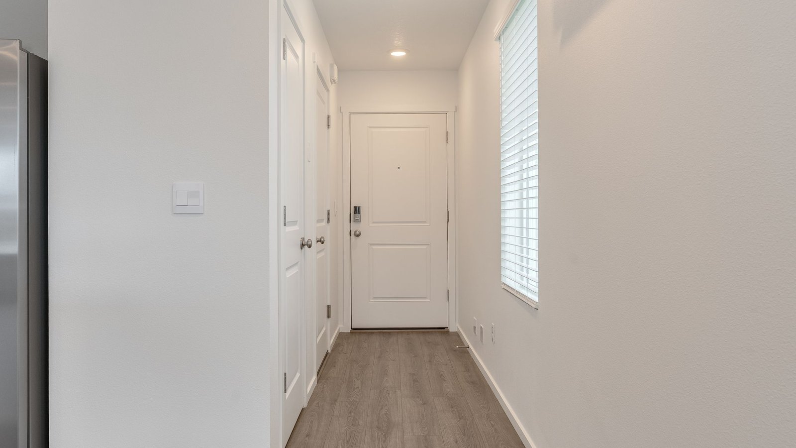Entryway with a coat closet and laminate flooring