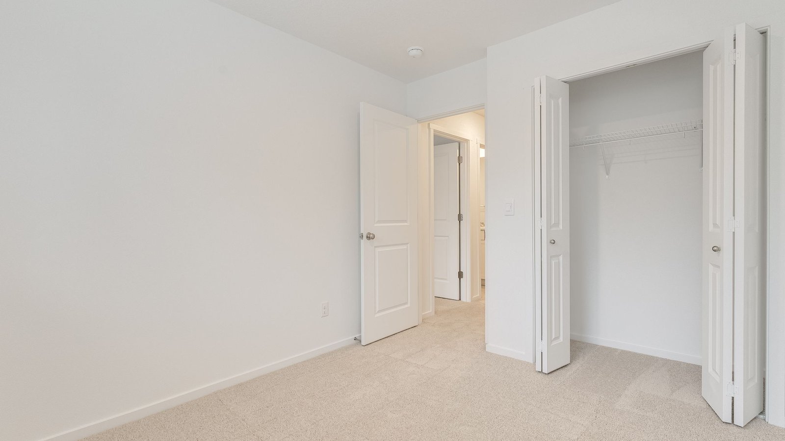 Bedroom with wall-to-wall carpet and a closet