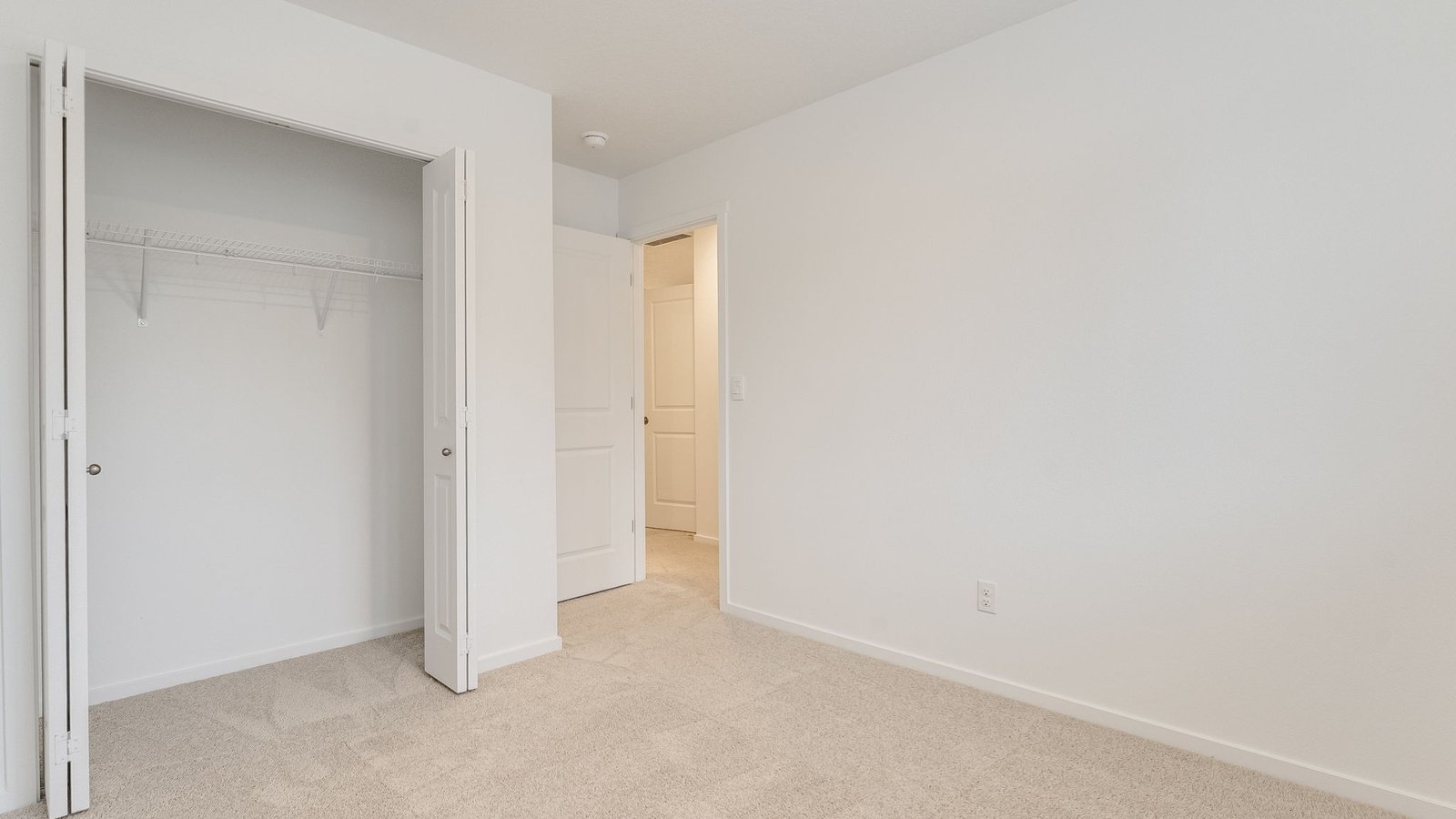 Bedroom with wall-to-wall carpet and a closet