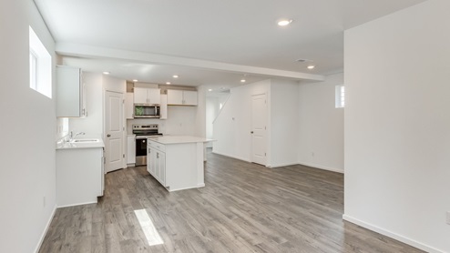 Great room with laminate flooring and an electric fireplace