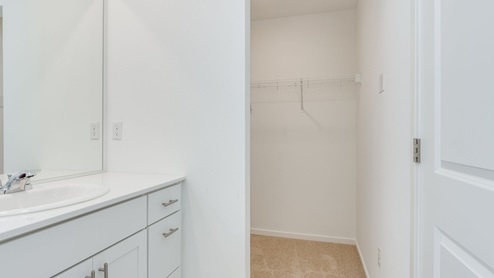 Primary bedroom walk-in closet with wire shelves