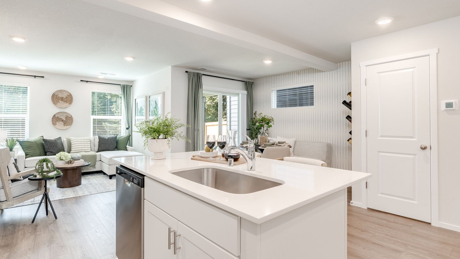 Kitchen with shaker cabinets, quartz counters, stainless steel appliances, pantry, and an island with a breakfast bar