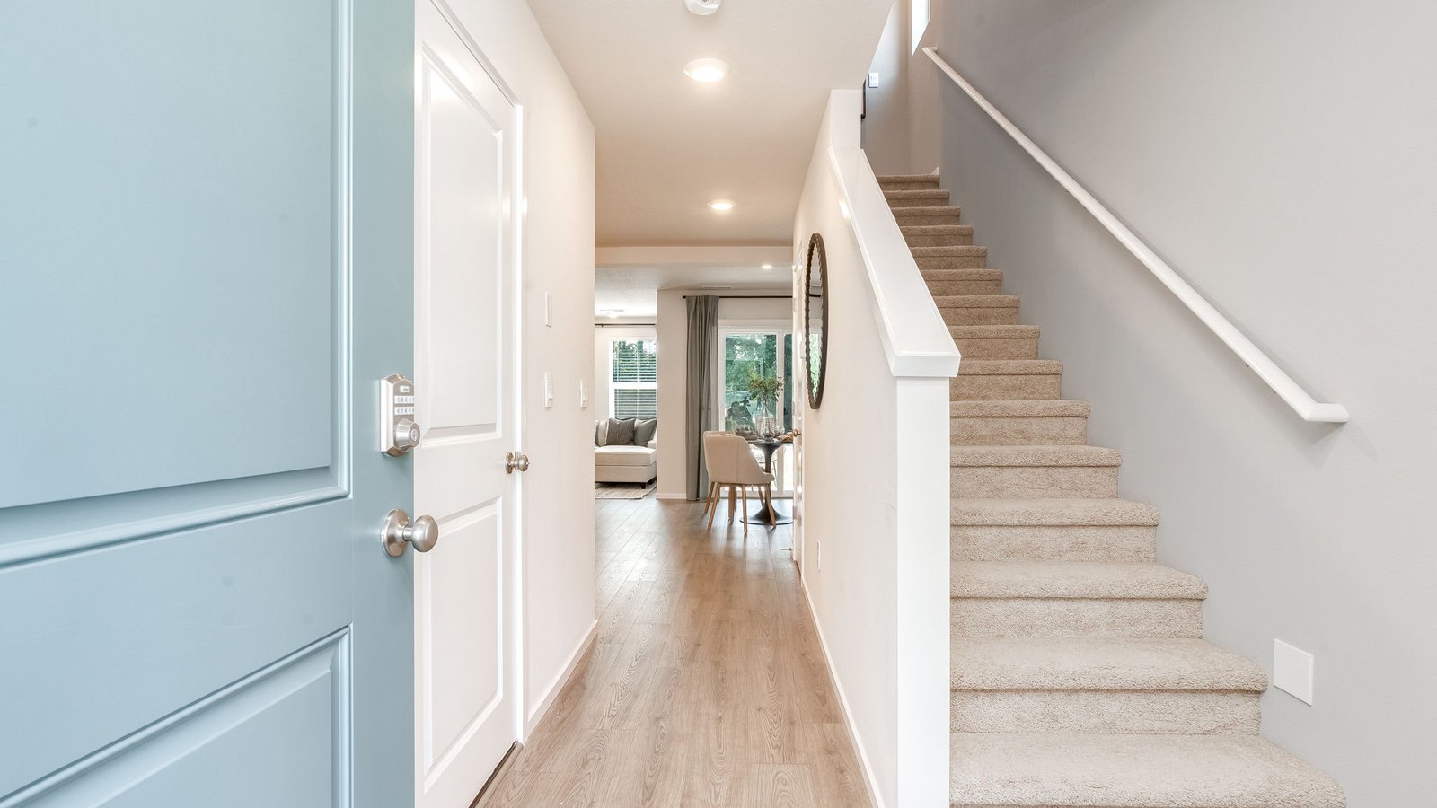 Entryway with a coat closet and laminate flooring