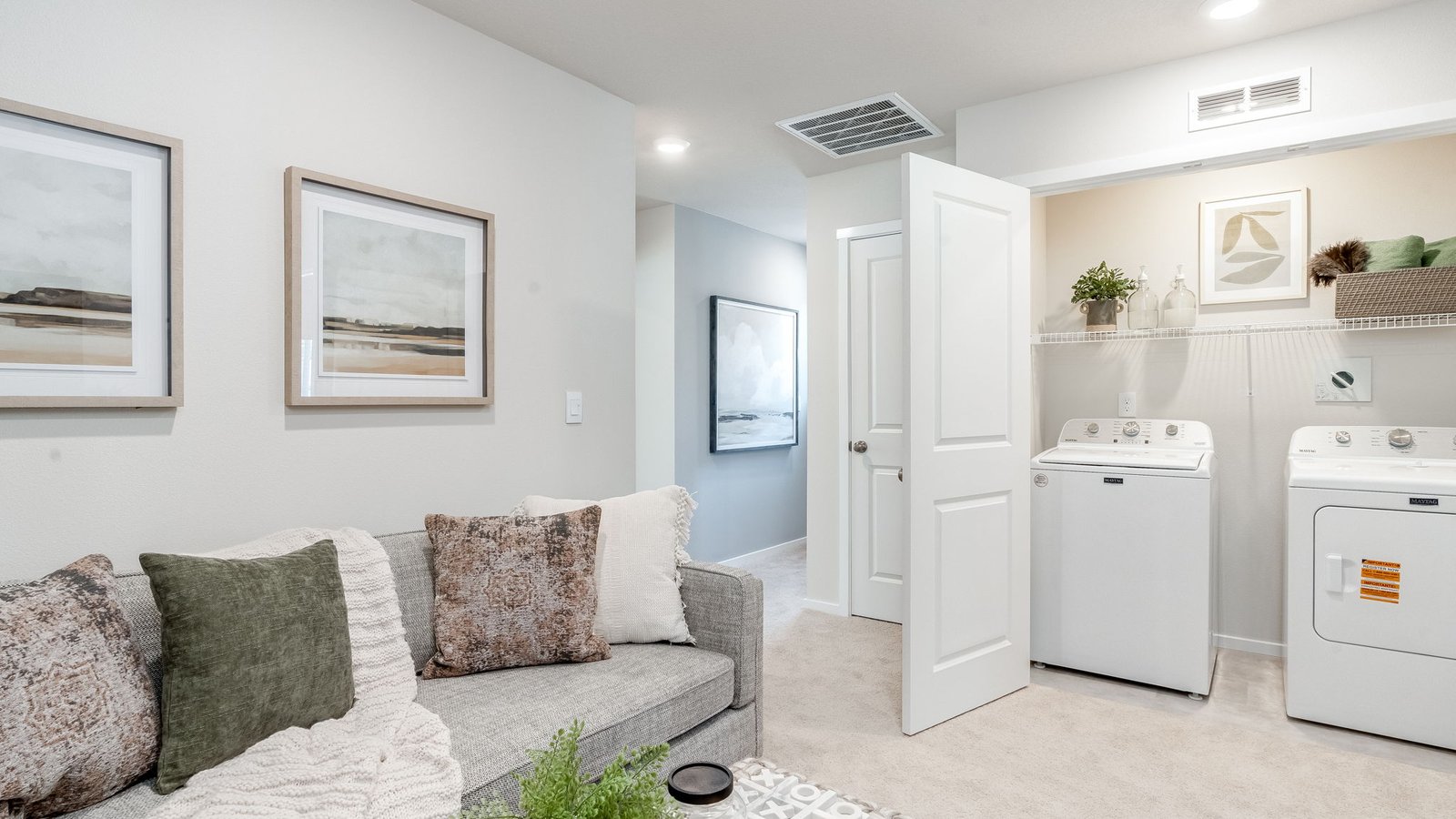 Laundry closet with wire shelves and washer and dryer hookups