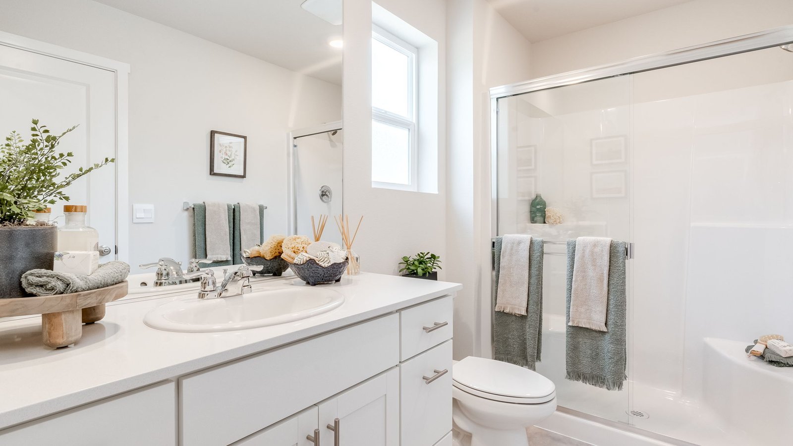 Primary bathroom with quartz counters and a walk-in shower