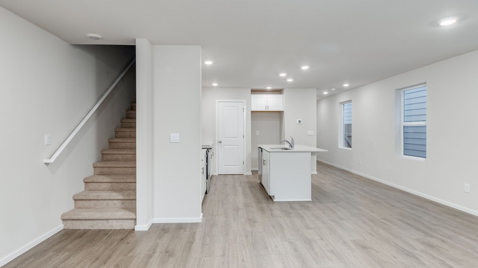 Great room with laminate flooring and an electric fireplace