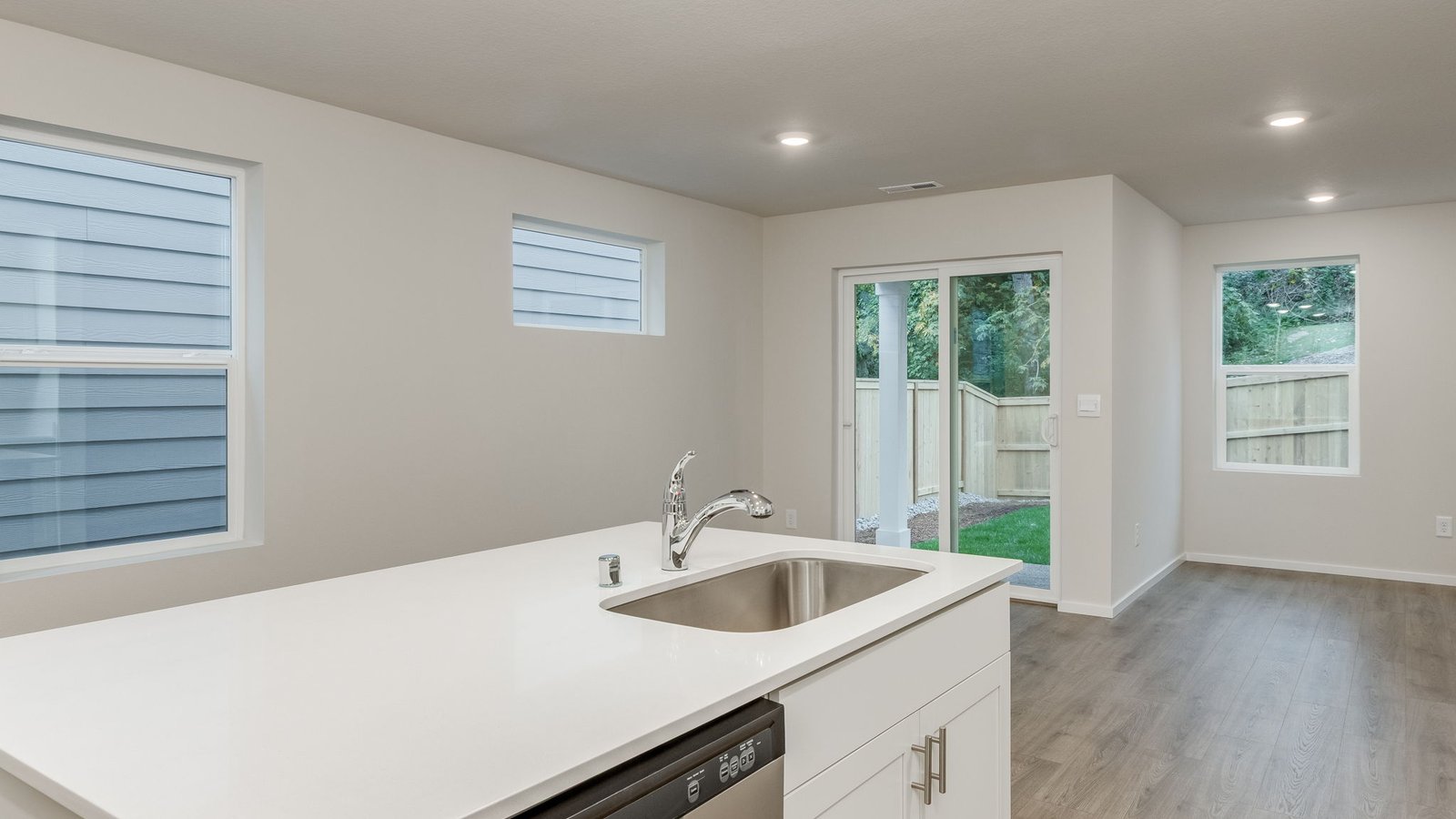 Kitchen with shaker cabinets, quartz counters, stainless steel appliances, pantry, and an island with a breakfast bar