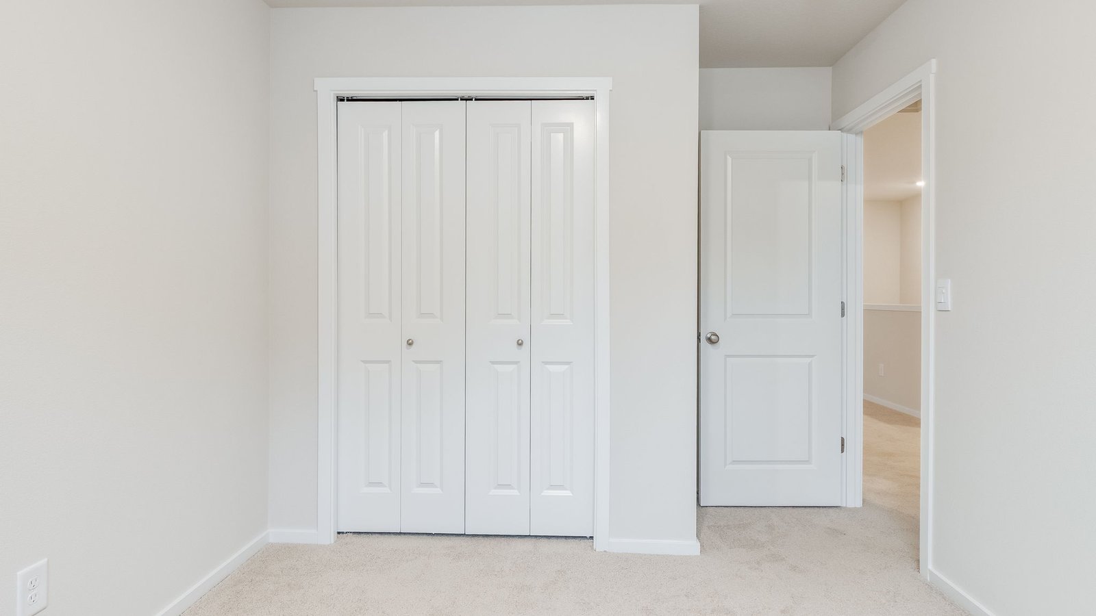 Bedroom with wall-to-wall carpet and a closet