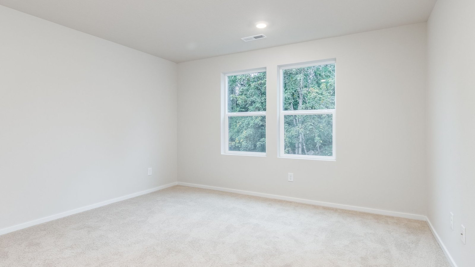 Primary bedroom with wall-to-wall carpet, a walk-in closet and an attached bathroom