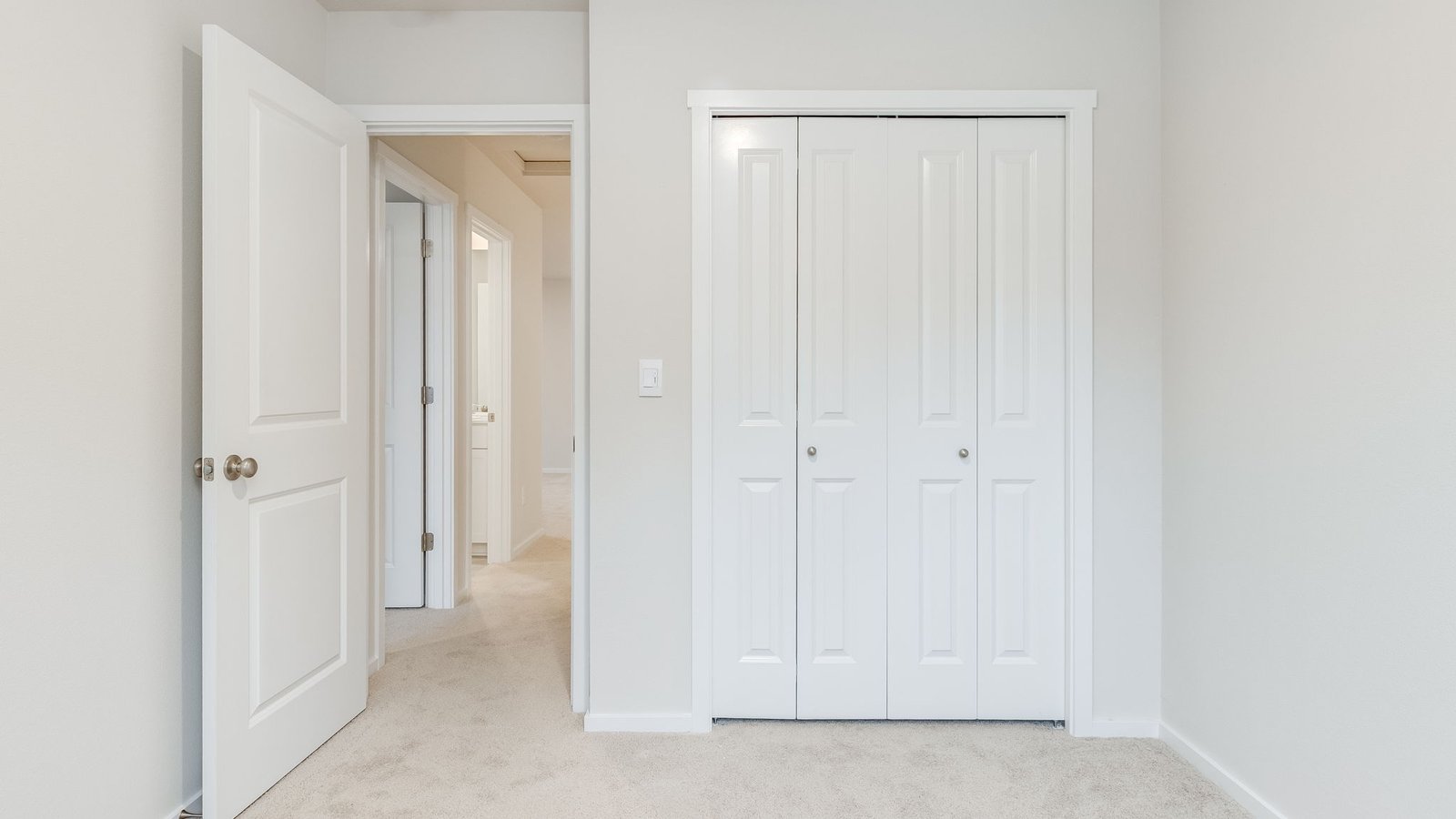 Bedroom with wall-to-wall carpet and a closet
