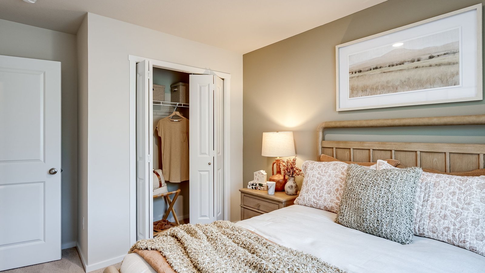 Bedroom with wall-to-wall carpet and a closet