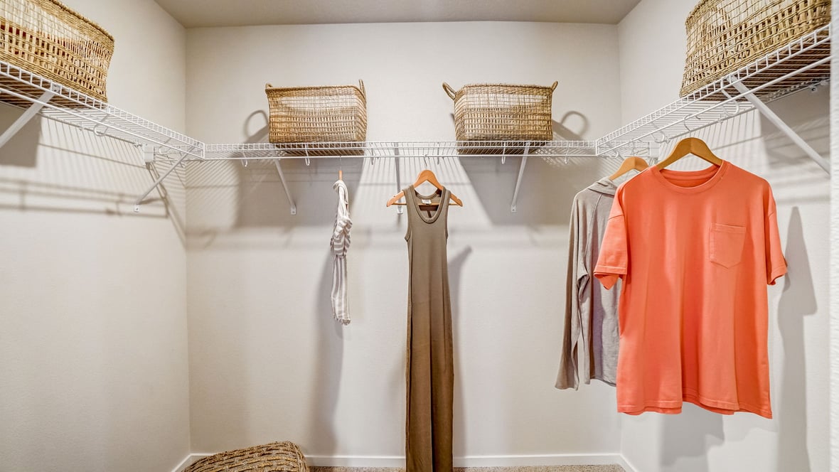 Primary bedroom walk-in closet with wire shelves