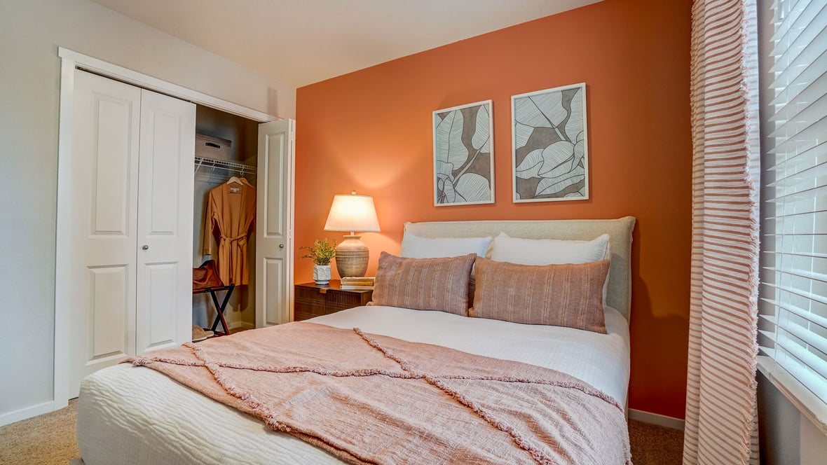 Bedroom with wall-to-wall carpet and a closet