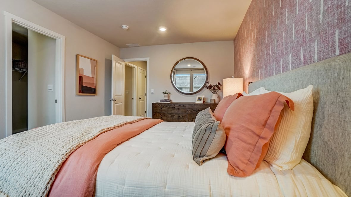 Primary bedroom with wall-to-wall carpet, a walk-in closet and an attached bathroom