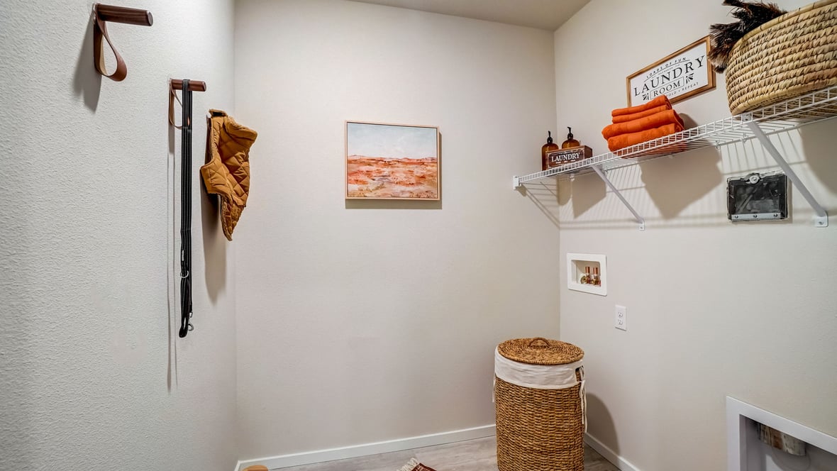 Laundry room with wire shelves and washer and dryer hookups