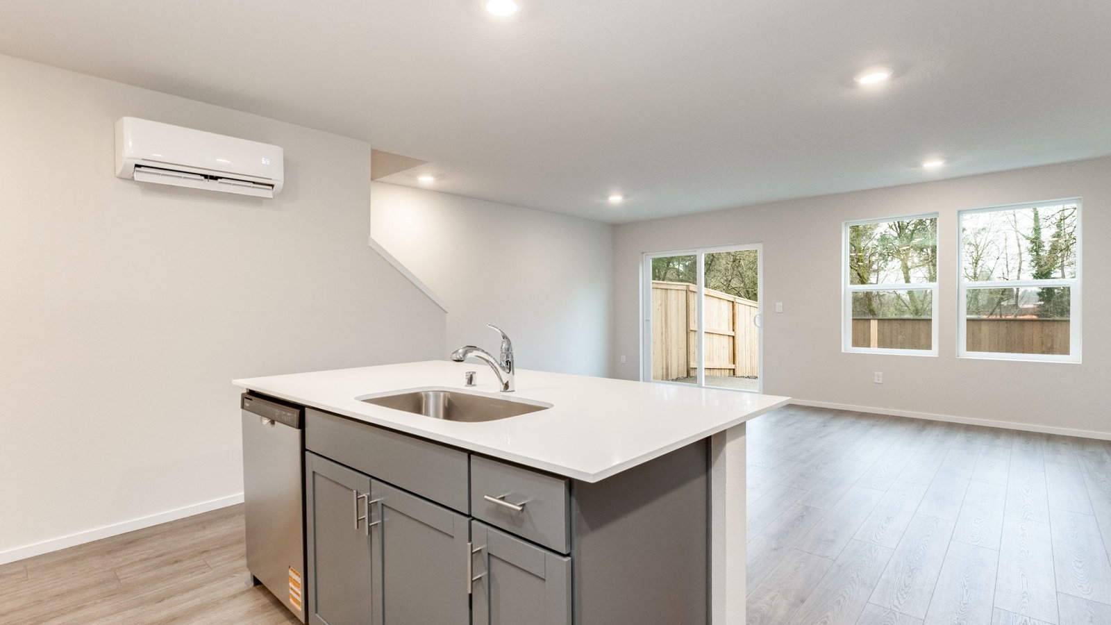 Kitchen with shaker cabinets, quartz counters, stainless steel appliances, pantry, and an island with a breakfast bar