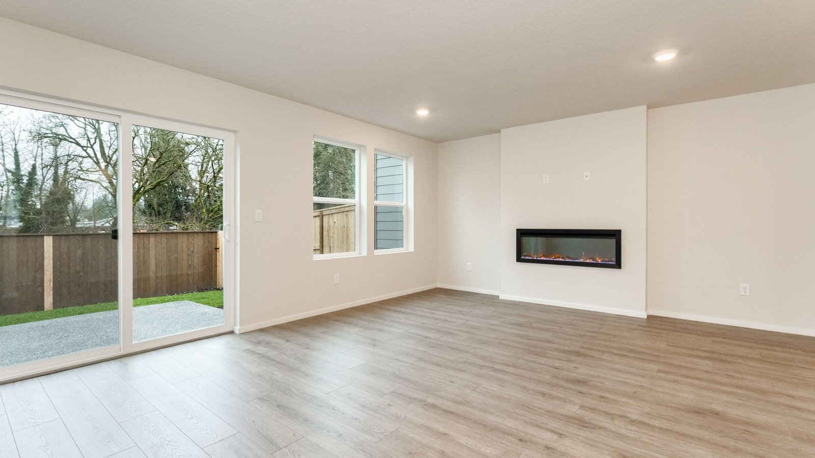 Great room with laminate flooring and an electric fireplace