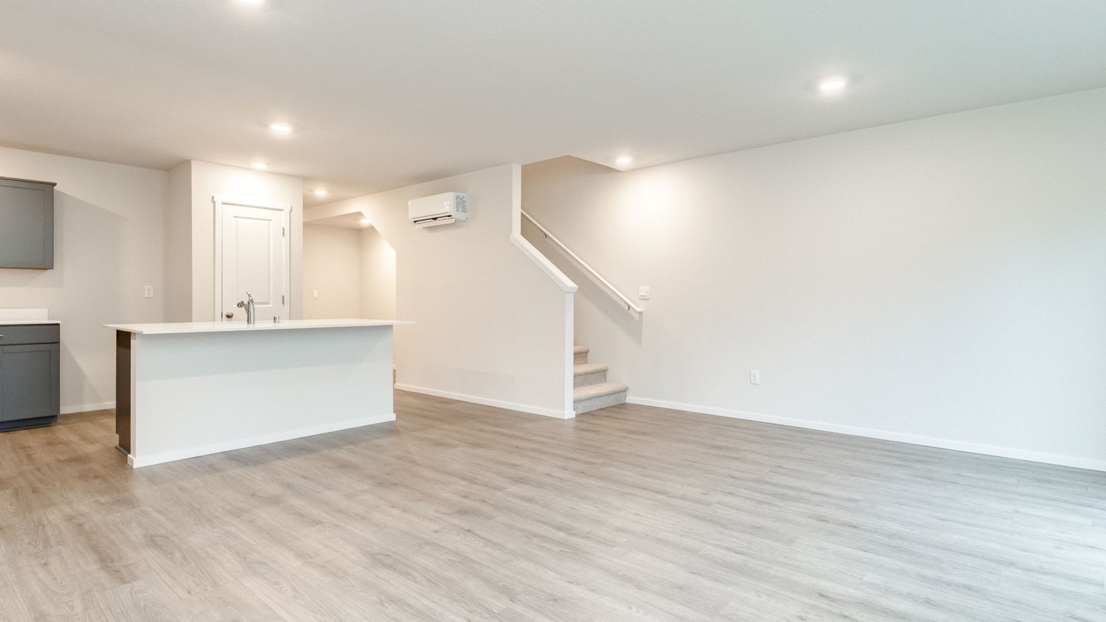 Great room with laminate flooring and an electric fireplace