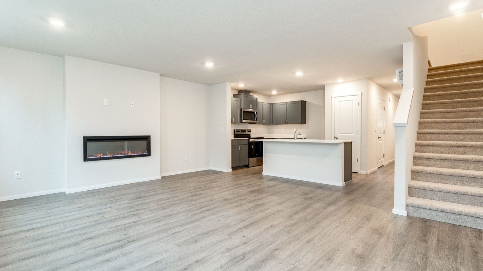 Great room with laminate flooring and an electric fireplace