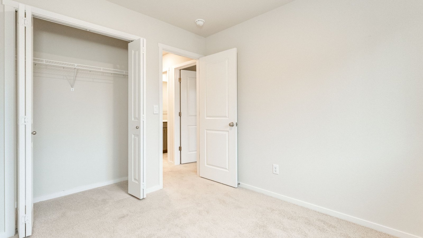 Bedroom with wall-to-wall carpet and a closet