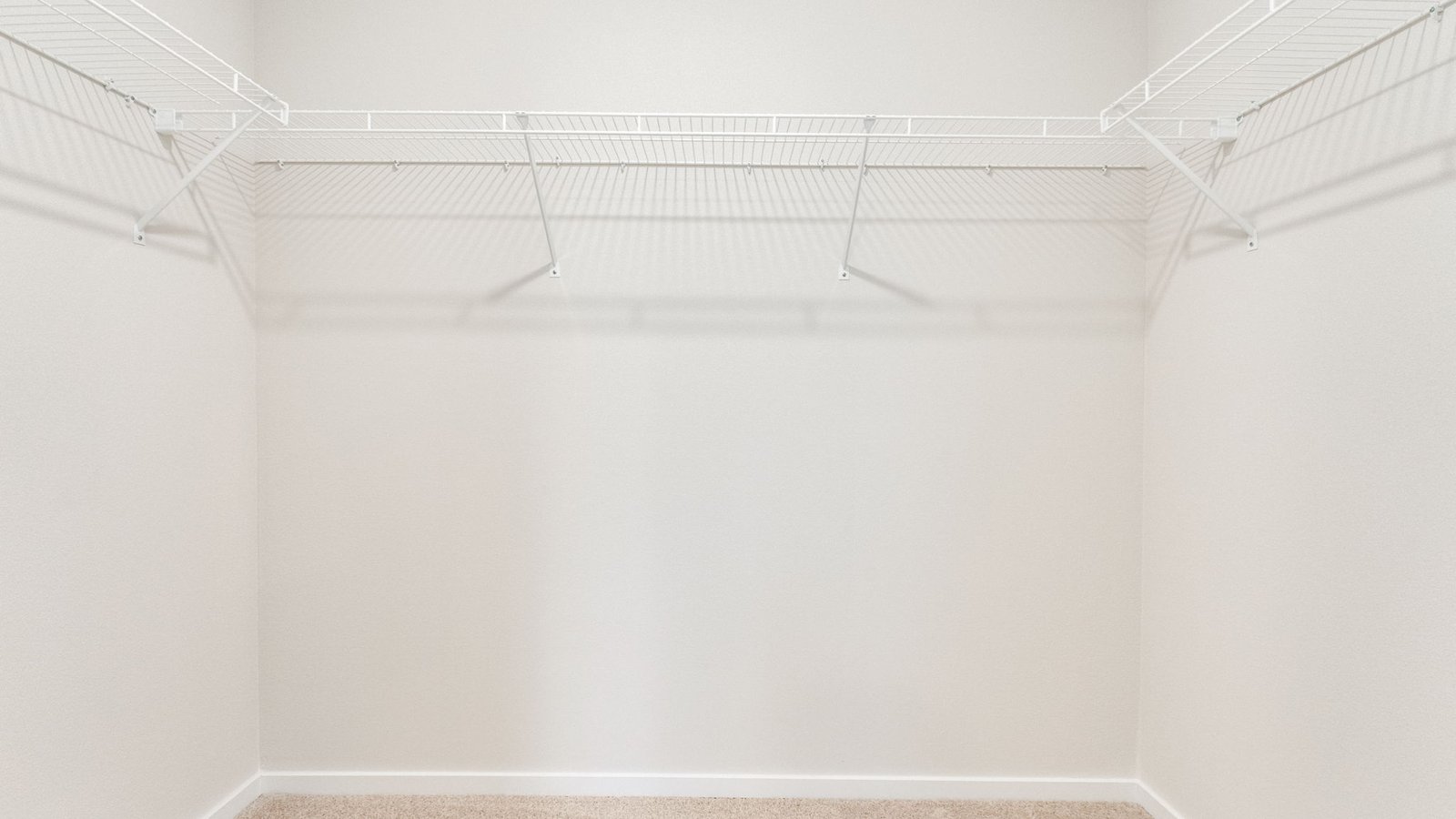 Primary bedroom walk-in closet with wire shelves