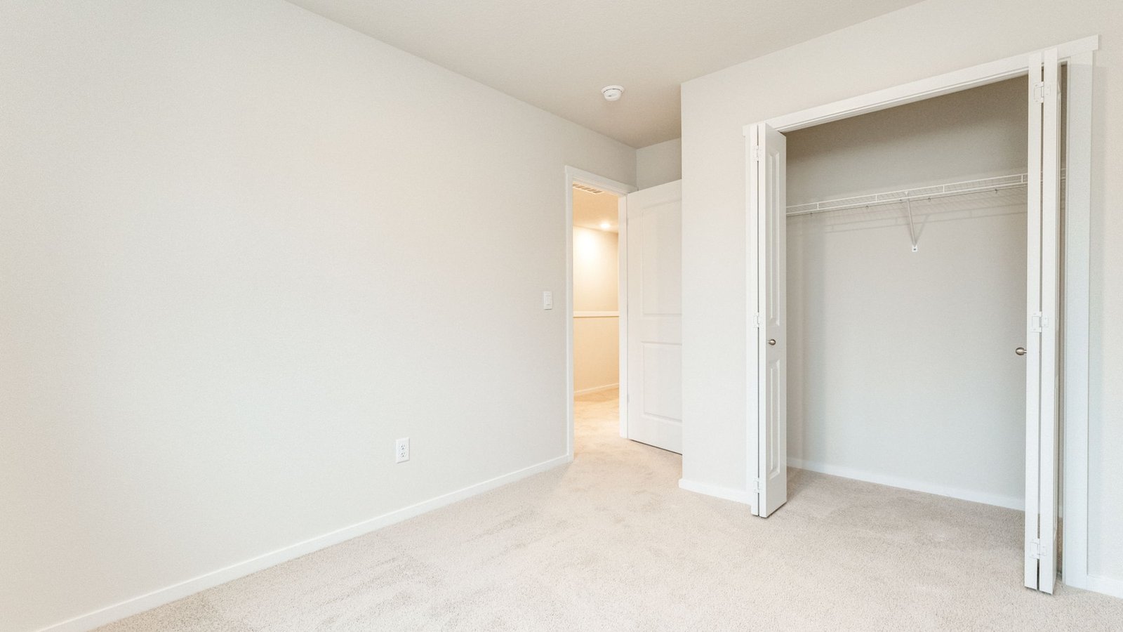Bedroom with wall-to-wall carpet and a closet