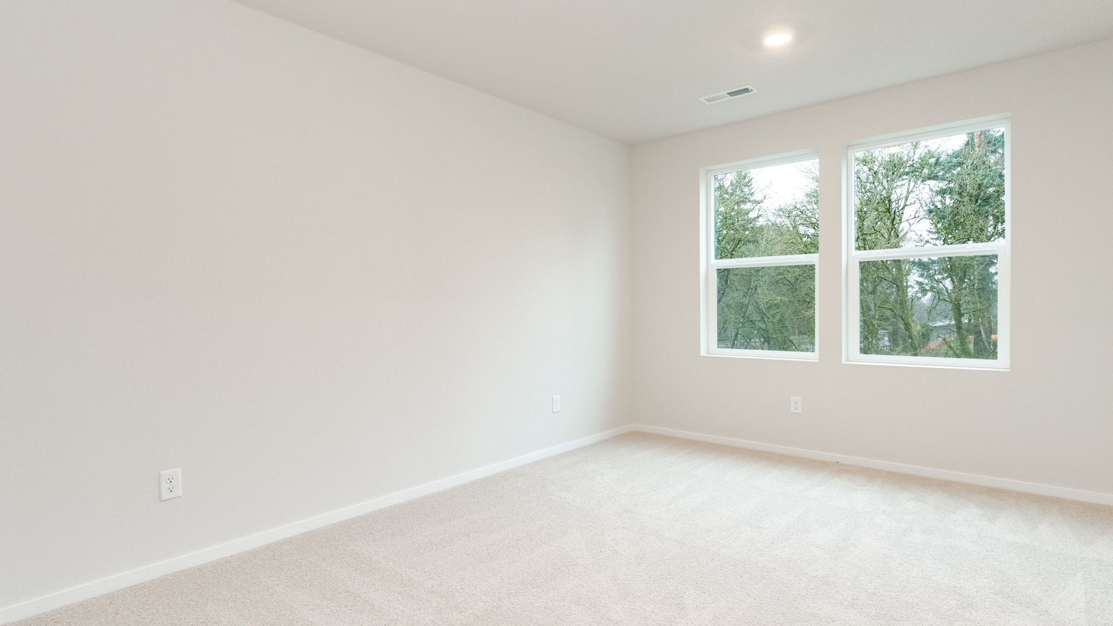 Primary bedroom with wall-to-wall carpet, a walk-in closet and an attached bathroom