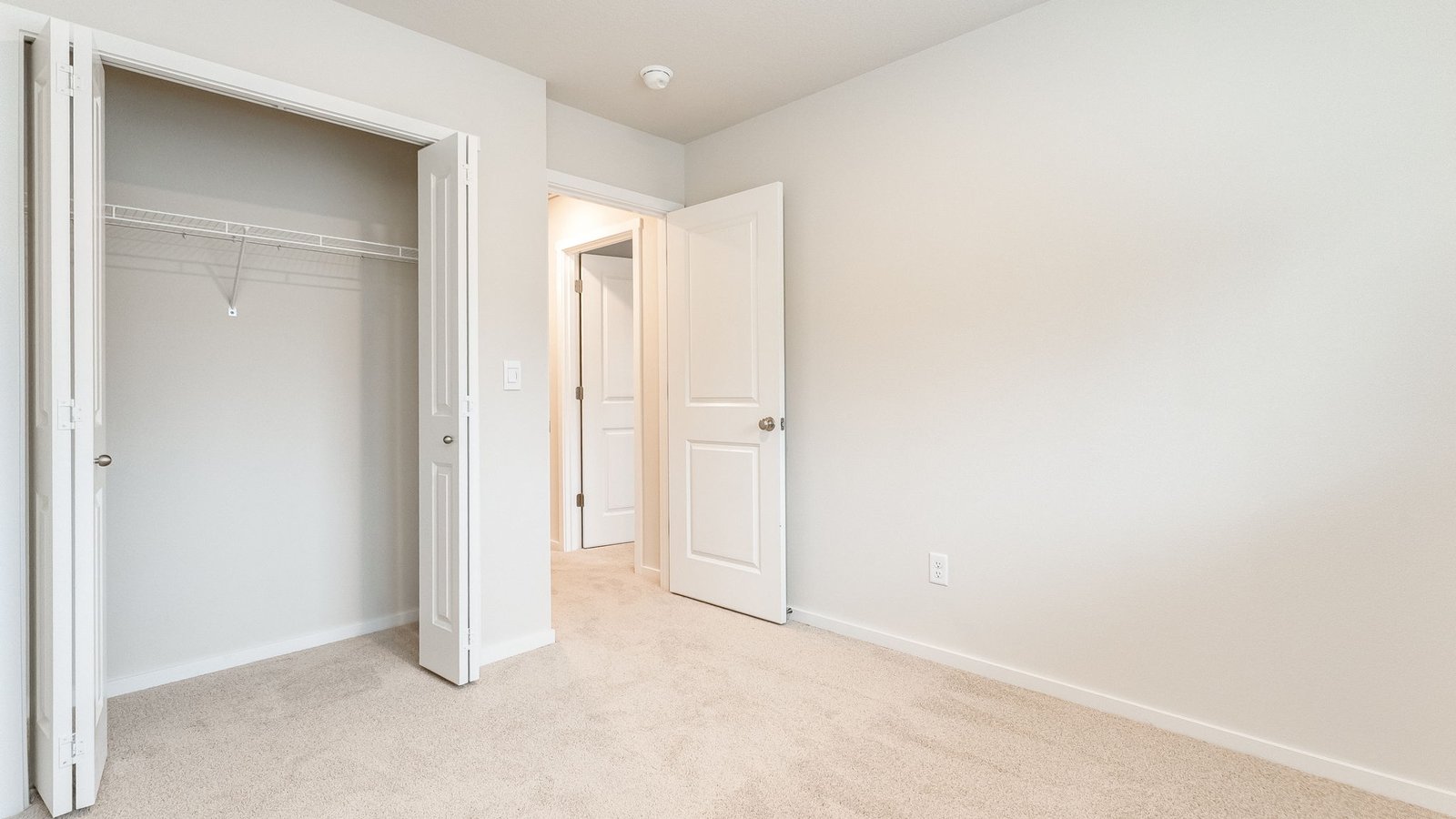 Bedroom with wall-to-wall carpet and a closet