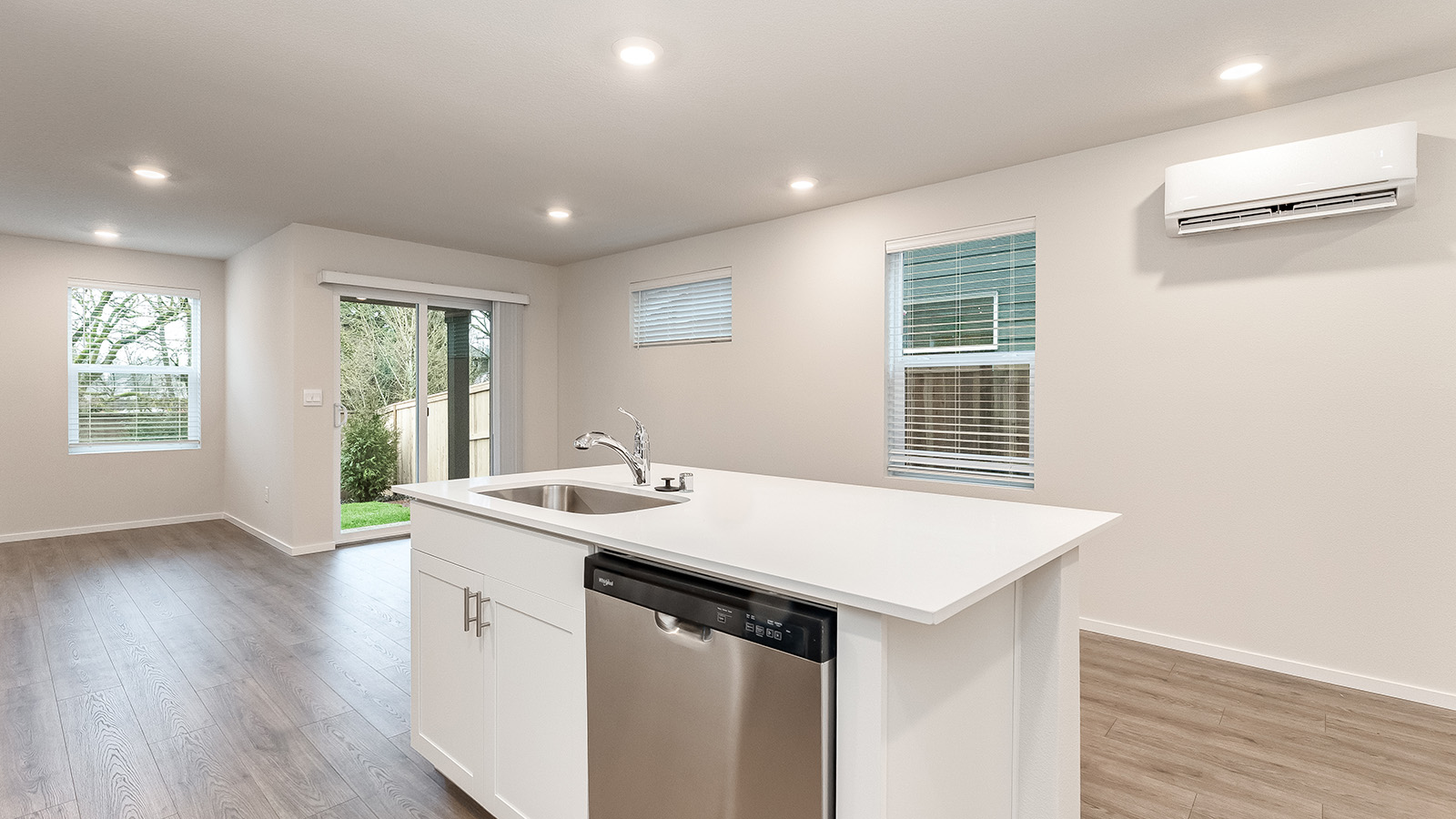 Kitchen with shaker cabinets, quartz counters, stainless steel appliances, pantry, and an island with a breakfast bar