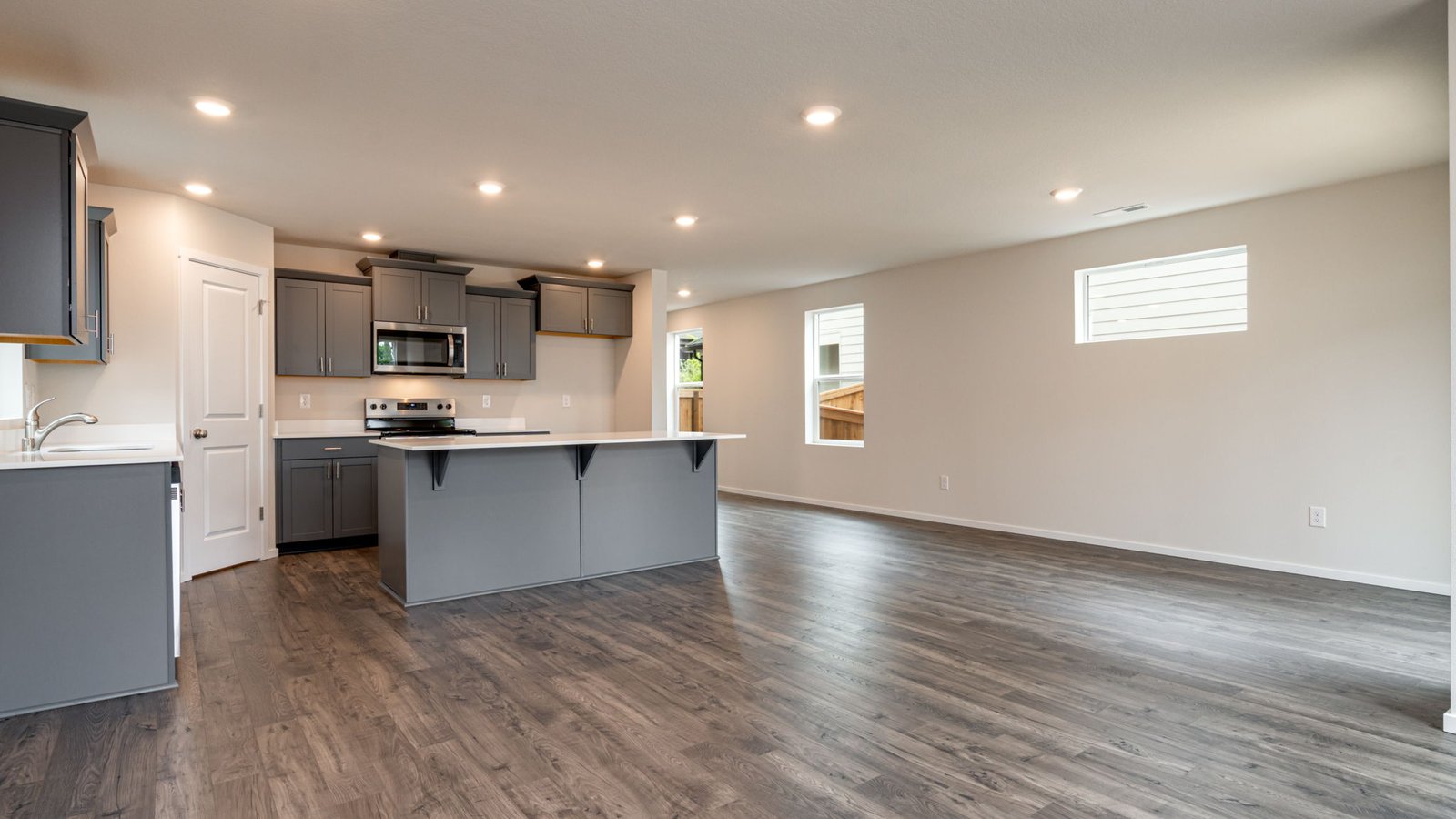 Great room with laminate flooring and an electric fireplace